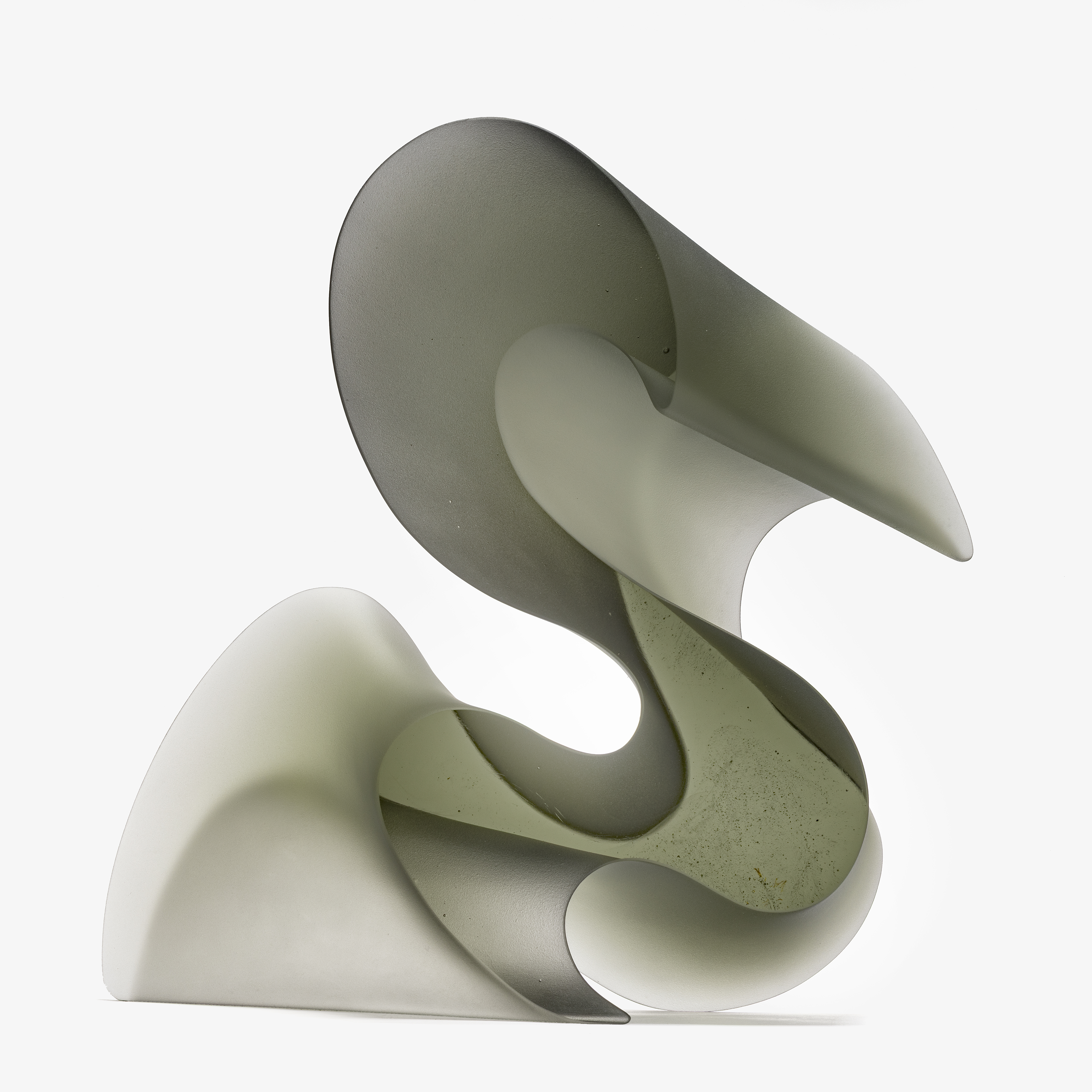 chunky transparent grey standing form that resembles flamboyant script and calligraphy and in particular the letter s hand made from cast glass