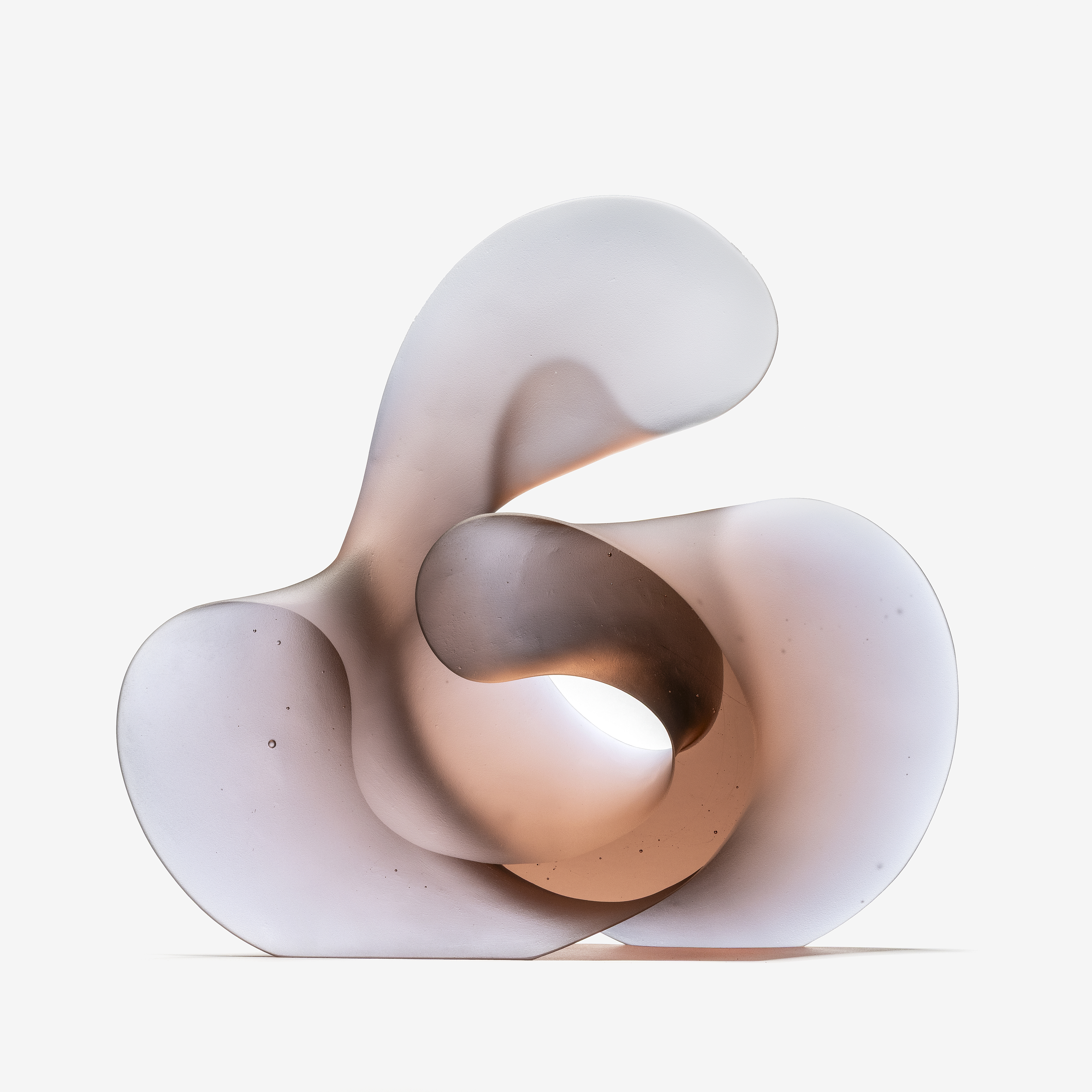 chunky curled semi transparent soft pink and pale lilac standing curled form with the appearance of calligraphy hand made from cast glass